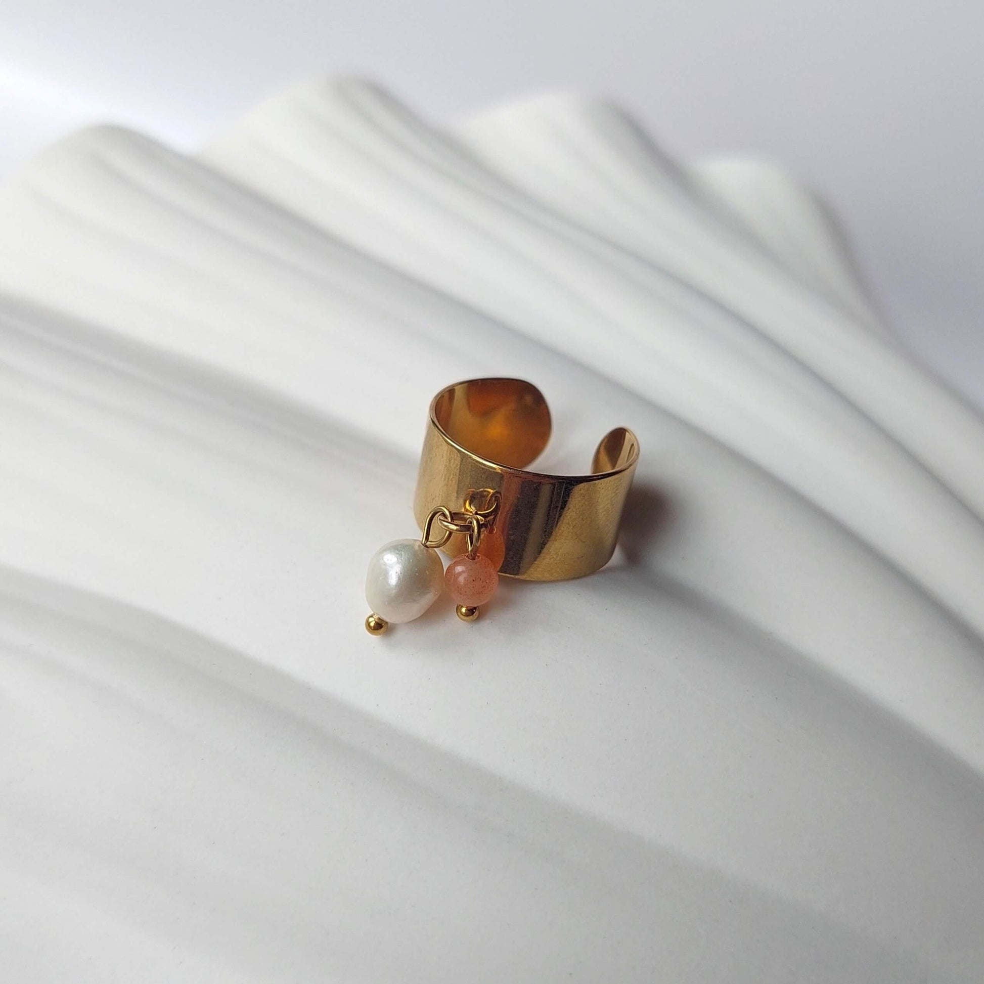 Bague en acier inoxydable à breloques de pierre de soleil et de perle d'eau douce.